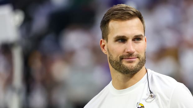 Minnesota Vikings quarterback Kirk Cousins stands on the sideline